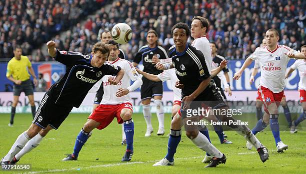 Tomas Rincon as well as Marcell Jansen of Hamburg and Benedikt Hoewedes as well as Jefferson Farfan of Schalke battle for the ball during the...