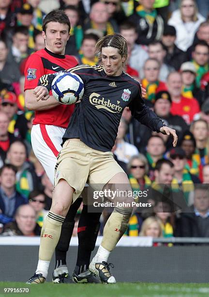 Michael Carrick of Manchester United clashes with Fernando Torres of Liverpool during the FA Barclays Premier League match between Manchester United...