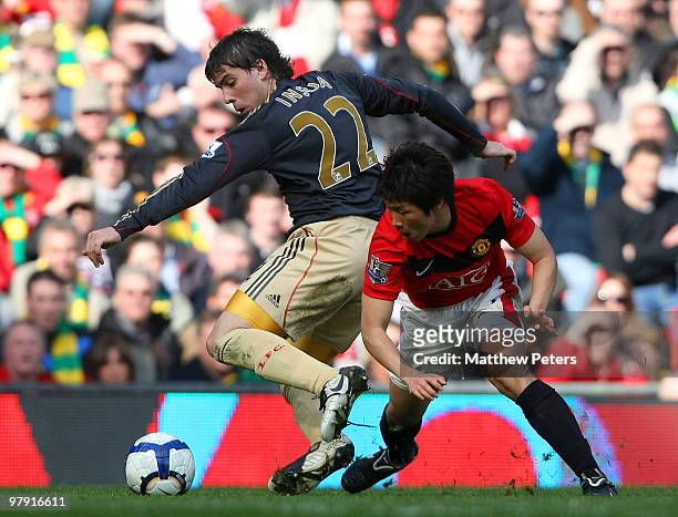 Ji-Sung Park of Manchester United clashes with Emiliano Insua of Liverpool during the FA Barclays Premier League match between Manchester United and...