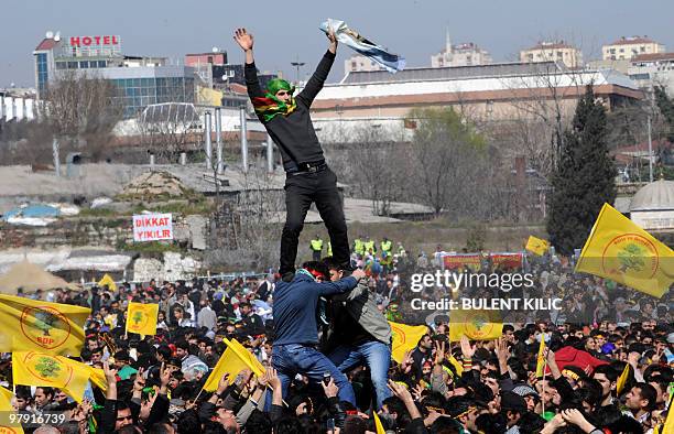 Turkish Kurds attempt to build a human tower during a rally along with other supporters as they wave Kurdish flags and chant slogan to celebrate the...