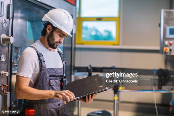factory worker checking plan for his night shift - shift worker stock pictures, royalty-free photos & images