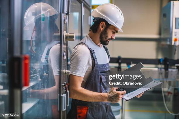 factory worker checking plan for his night shift - shift worker stock pictures, royalty-free photos & images