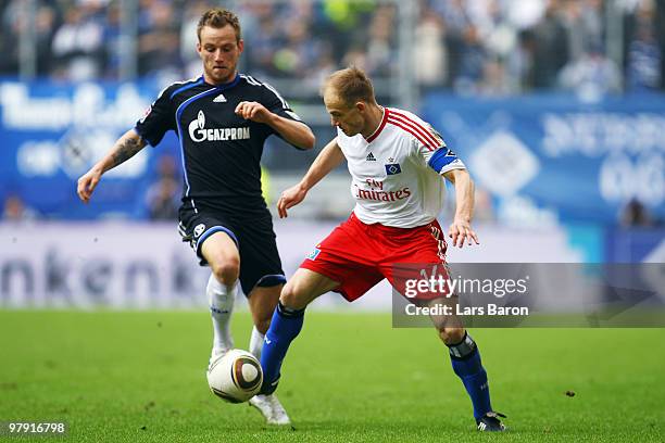 Ivan Rakitic of Schalke and David Jarolim of Hamburg battle for the ball during the Bundesliga match between Hamburger SV and FC Schalke 04 at HSH...