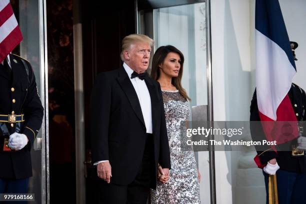 President Donald J. Trump and first lady Melania Trump walk out to the North Portico to greet French President Emmanuel Macron and his wife Brigitte...