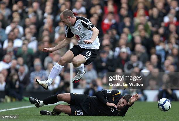 Danny Murphy of Fulham rides the tackle of Javier Garrido of Manchester City during the Barclays Premier League match between Fulham and Manchester...