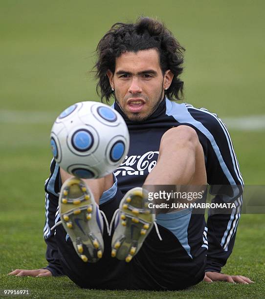 Argentina's National Football team footballer Carlos Tevez juggles with the ball during a training session in Buenos Aires on September 3, 2009....
