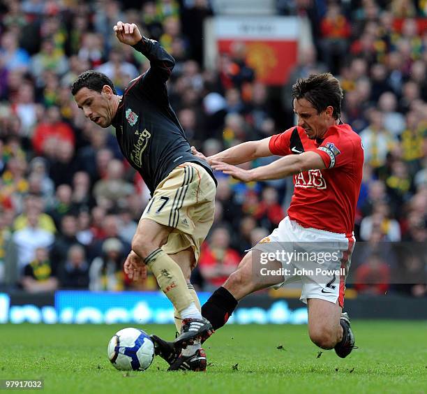 Maxi Rodriguez of Liverpool competes with Gary Neville of Manchester United during the Barclays Premier League match between Manchester United and...