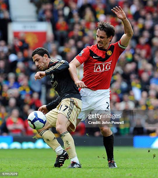 Maxi Rodriguez of Liverpool competes with Gary Neville of Manchester United during the Barclays Premier League match between Manchester United and...