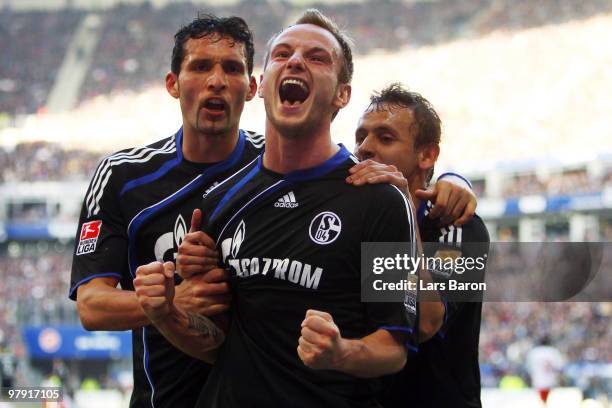 Ivan Rakitic of Schalke celebrates with team mates Rafinha and Kevin Kuranyi after scoring his team's second goal during the Bundesliga match between...