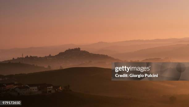 village on hills in fog, roddi, piedmont, italy - roddi stock pictures, royalty-free photos & images
