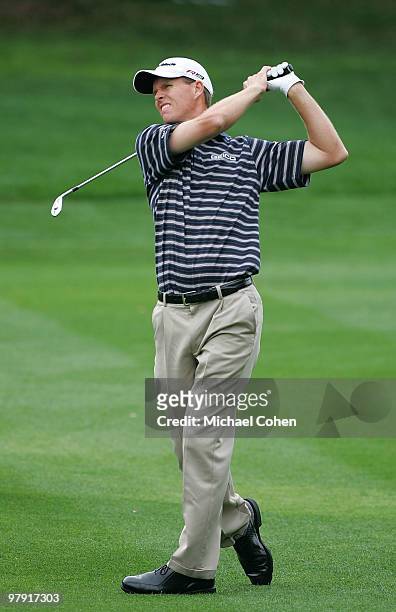 John Senden of Australia hits his second shot on the first hole during the final round of the Transitions Championship at the Innisbrook Resort and...