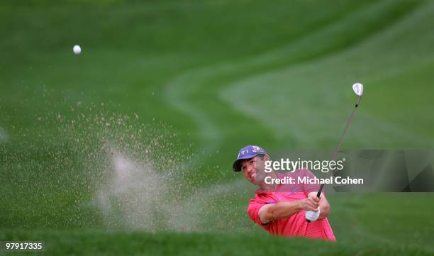 Padraig Harrington of Ireland hits his third shot on the first hole from a bunker during the final round of the Transitions Championship at the...