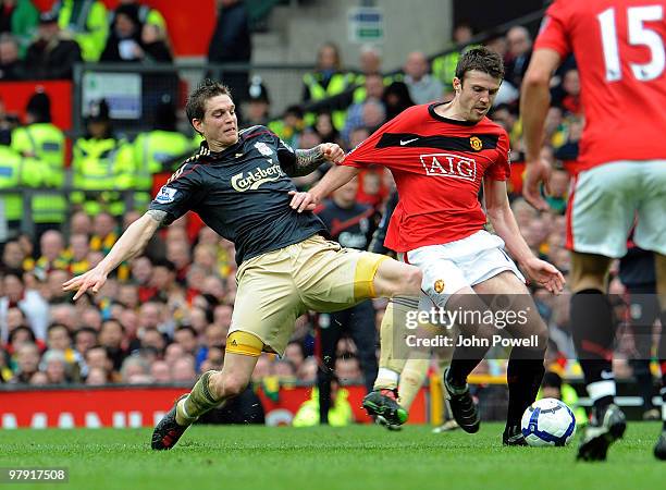 Daniel Agger of Liverpool competes with Michael Carrick of Manchseter United during the Barclays Premier League match between Manchester United and...