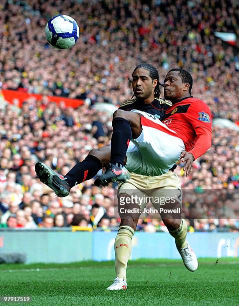 Glen Johnson of Liverpool watch's as Patrice Evra of Manchester United during the Barclays Premier League match between Manchester United and...