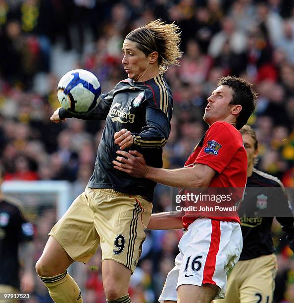 Fernando Torres of Liverpool competes with Michael Carrick of Manchester United during the Barclays Premier League match between Manchester United...