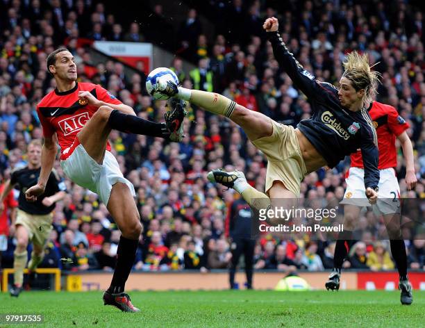 Fernando Torres of Liverpool clashes with Rio Ferdinand of Manchester United during the Barclays Premier League match between Manchester United and...