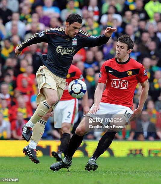 Maxi Rodriguez of Liverpool competes with Michael Carrick of Manchseter United during the Barclays Premier League match between Manchester United and...