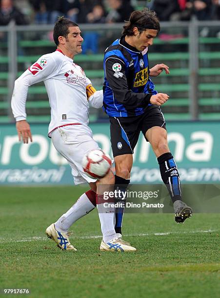 Federico Peluso of Atalanta competes with Cristiano Lucarelli of Livorno during the Serie A match between Atalanta BC and AS Livorno Calcio at Stadio...