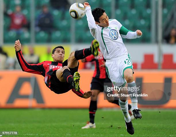 Makoto Hasebe of Wolfsburg is challenged by Cicero of Berlin during the Bundesliga match between VfL Wolfsburg and Hertha BSC Berlin at Volkswagen...