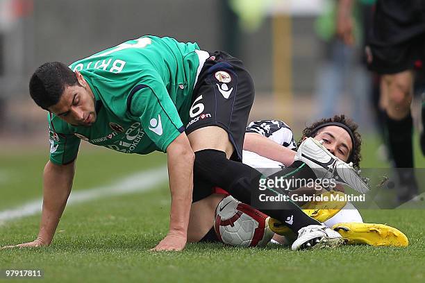 Marcelo Larrondo of AC Siena tangles with Miguel Angel Britos of Bologna FC during the Serie A match between AC Siena and Bologna FC at Stadio...