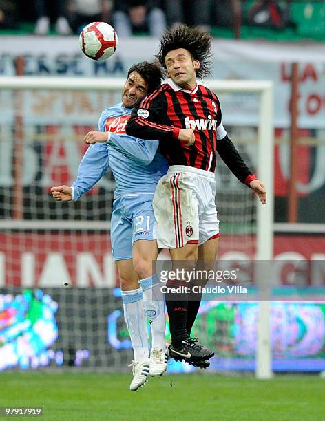 Andrea Pirlo of AC Milan competes for a header with Luca Cigarini of SSC Napoli during the Serie A match between AC Milan and SSC Napoli at Stadio...