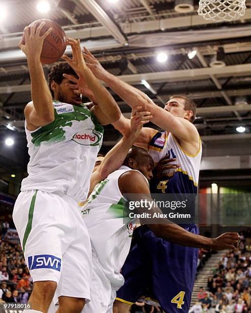 Marko Scekic of Oldenburg and George Evans battle for the ball with Chris Copeland of Trier during the Beko BBL basketball match between TBB Trier...