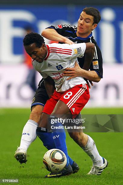 Alexander Baumjohann of Schalke challenges Ze Roberto of Hamburg during the Bundesliga match between Hamburger SV and FC Schalke 04 at HSH Nordbank...