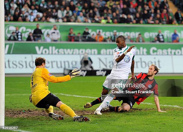 Grafite of Wolfsburg scores his team's first goal against goalkeeper Jaroslav Drobny of Hertha during the Bundesliga match between VfL Wolfsburg and...