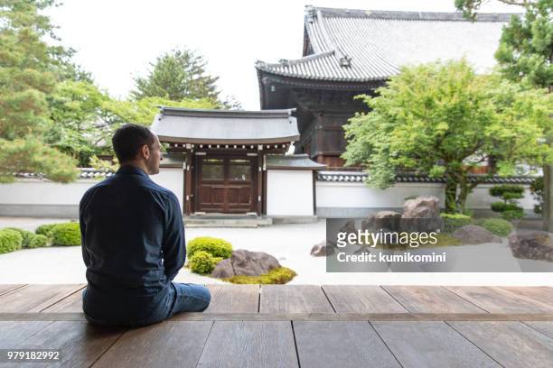 kaukasischen mann betrachten tempelgarten - daily life in kyoto stock-fotos und bilder