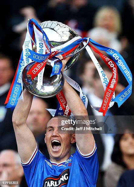 Rangers goal scorer Kenny Miller lifts the CIS Insurance Cup after beating St Mirren 1-0 in the final at Hampden Park on March 21, 2010 in Glasgow,...