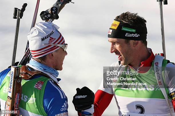 Ivan Tcherezov of Russia shakes hands with Christoph Sumann of Austria after the men's mass start in the E.On Ruhrgas IBU Biathlon World Cup on March...