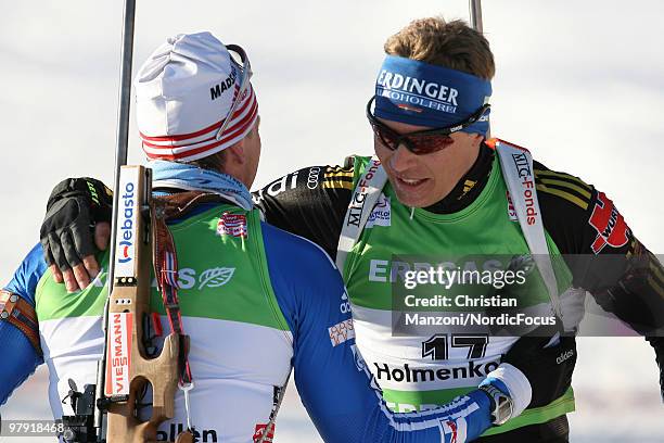 Andreas Birnbacher of Germany congratulates race winner Ivan Tcherezov of Russia after the men's mass start in the E.On Ruhrgas IBU Biathlon World...