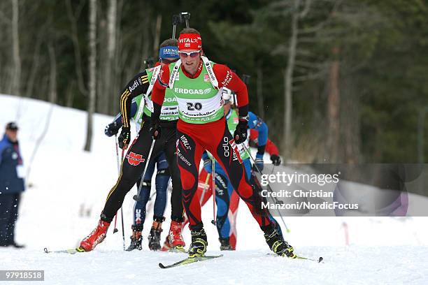 Alexander Os of Norway competes ahead of Andreas Birnbacher of Germany during the men's mass start in the E.On Ruhrgas IBU Biathlon World Cup on...