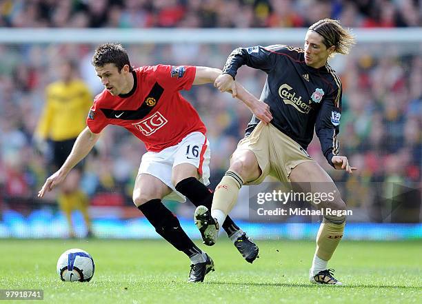 Michael Carrick of Manchester United battles Fernando Torres of Liverpool during the Barclays Premier League match between Manchester United and...