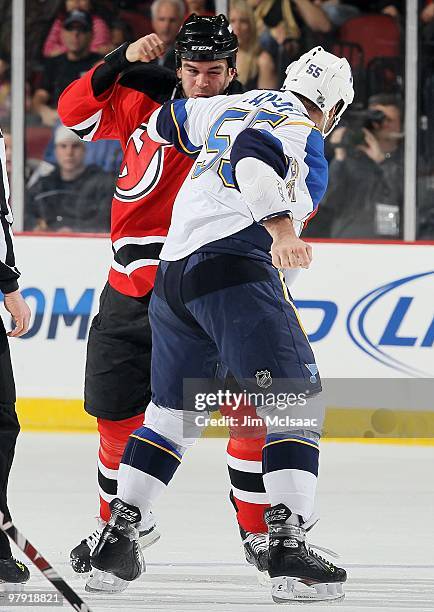 Cam Janssen of the St. Louis Blues trades punches with Pierre-Luc Letourneau-Leblond of the New Jersey Devils during their first period fight at the...