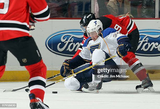 Oshie of the St. Louis Blues skates against Travis Zajac of the New Jersey Devils at the Prudential Center on March 20, 2010 in Newark, New Jersey....