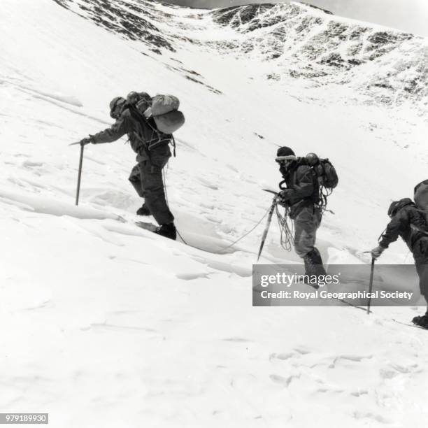 Hillary and Tenzing on the shelf at the top of the Lhotse glacier during the second assault, The flag intended for the summit can be seen wrapped...