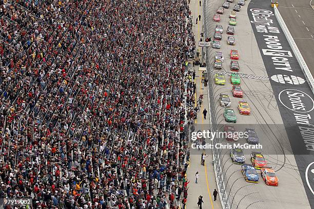 Joey Logano, driver of the Home Depot Toyota, and Kurt Busch, driver of the Miller Lite Dodge, lead the field to the green flag to start the NASCAR...