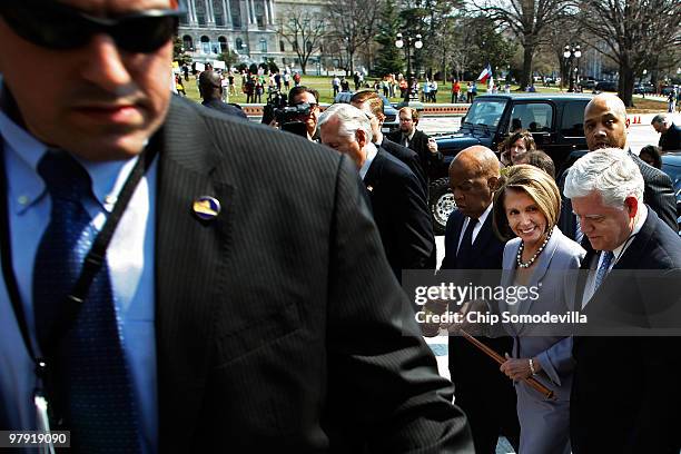 Speaker of the House Rep. Nancy Pelosi carries the gavel that was used when Medicare was passed while marching with Rep. John Lewis , Majority Leader...