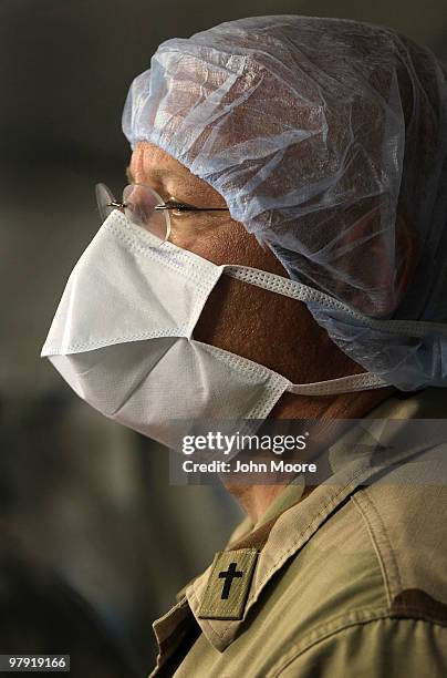 Navy Chaplain LCDR. Charles Hodges watches as doctors perform brain surgery on an Afghan civilian on March 21, 2010 at the military hospital at...