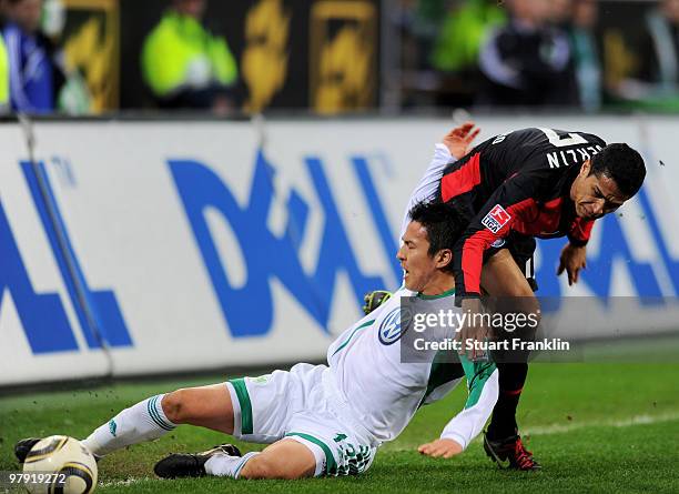 Makoto Hasebe of Wolfsburg is challenged by Cicero of Berlin during the Bundesliga match between VfL Wolfsburg and Hertha BSC Berlin at Volkswagen...