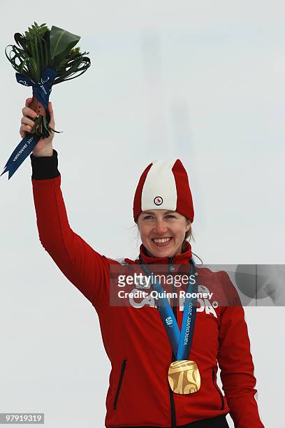 Gold medalist Lauren Woolstencroft of Canada celebrates at the medal ceremony for the Women's Standing Super Combined during Day 9 of the 2010...