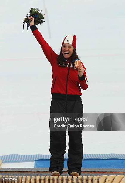 Bronze medalist Karolina Wisniewska of Canada celebrates at the medal ceremony for the Women's Standing Super Combined during Day 9 of the 2010...