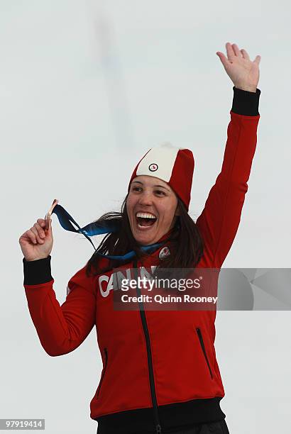 Bronze medalist Karolina Wisniewska of Canada celebrates at the medal ceremony for the Women's Standing Super Combined during Day 9 of the 2010...
