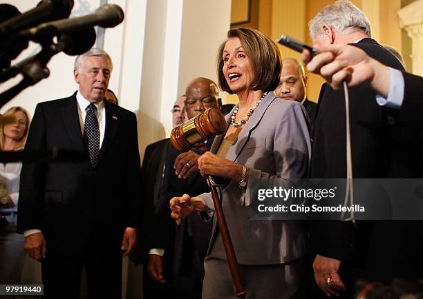 Speaker of the House Rep. Nancy Pelosi emerges from the Democratic caucus meeting carrying the gavel that was used when Medicare was passed in the...