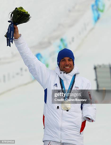 Silver medalist Vincent Gauthier-Manuel of France celebrates at the medal ceremony for the Men's Standing Super Combined during Day 9 of the 2010...