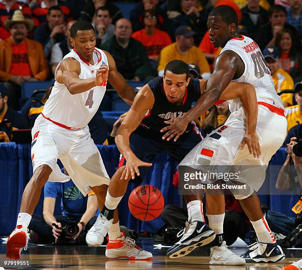 Wes Johnson and Rick Jackson of the Syracuse Orange defend against Elias Harris of the Gonzaga Bulldogs during the second round of the 2010 NCAA...