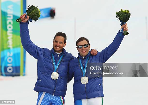 Silver medalist Gianmaria Dal Maistro of Italy and guide Tommaso Balasso celebrate at the medal ceremony for the Men's Visually Impaired Super...