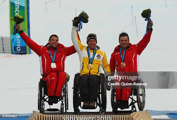 Gold medalist Martin Braxenthaler of Germany celebrates with silver medalist Jurgen Egle of Austria and bronze medalist Philipp Bonadimann of Austria...