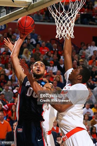 Robert Sacre of the Gonzaga Bulldogs shoots over DaShonte Riley of the Syracuse Orange during the second round of the 2010 NCAA men's basketball...
